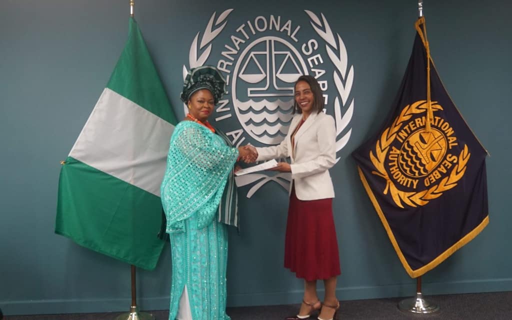 The Ambassador of Nigeria presents her credentials beside the flags of Nigeria and ISA
